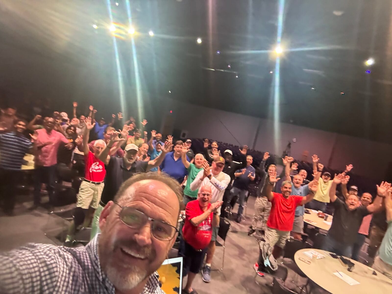 David A. Ogden taking a selfie with a crowd of people behind him